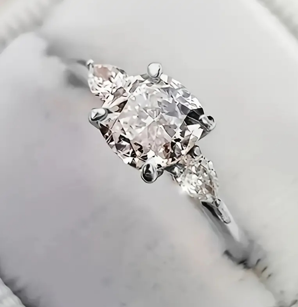 A Stylish Classic 4-prong Set With Three Sparkling Zirconia Engagement Ring
